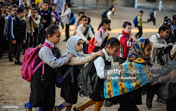 Egyptian students go to their classes at a primary school, where nearly 2 thousand students get education, after the Egyptian national anthem...