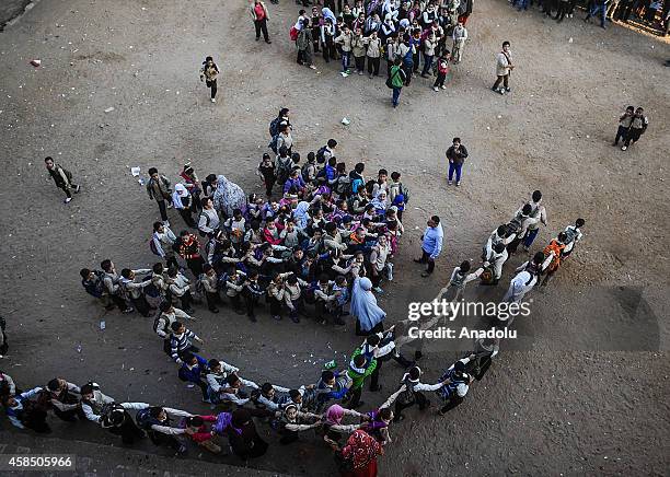 Egyptian students go to their classes at a primary school, where nearly 2 thousand students get education, after the Egyptian national anthem...