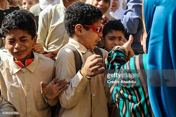 An Egyptian student is punished by his teacher at the garden of a primary school, where nearly 2 thousand students get education, in Baragil...