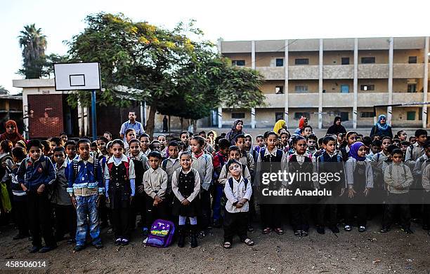 Egyptian students are seen at the garden of a primary school, where nearly 2 thousand students get education, ahead of the Egyptian national anthem...