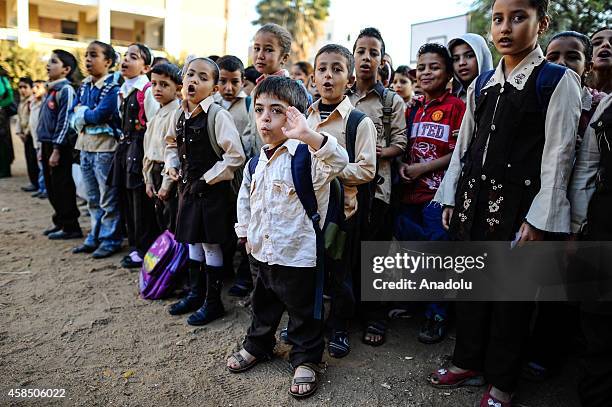 Egyptian students are seen at the garden of a primary school, where nearly 2 thousand students get education, during the Egyptian national anthem...