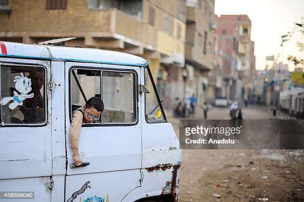 An Egyptian student tries to open the door of a school service at a primary school, where nearly 2 thousand students get education, in Baragil...