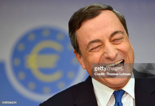 Mario Draghi, President of the European Central Bank, laughs as he speaks to the media following the monthly ECB board meeting on November 6, 2014 in...