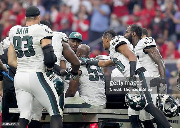 DeMeco Ryans of the Philadelphia Eagles is helped off of the field after getting injured while playing the Houston Texans in a NFL game on November...