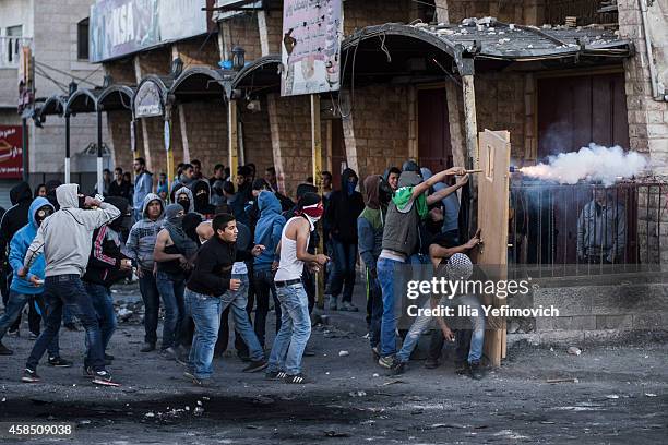 Palestinian youth clash with police at Shuafat refugee camp a day after a Palestinian resident of the camp was named as the driver of a van that...