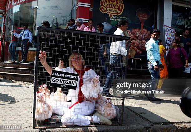 Founder Ingrid Newkirk caged herself with some dummy chicken to portray the conditions of chicken, which are slaughtered, for World Vegan Month at...