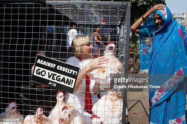 Founder Ingrid Newkirk caged herself with some dummy chicken to portray the conditions of chicken, which are slaughtered, for World Vegan Month at...