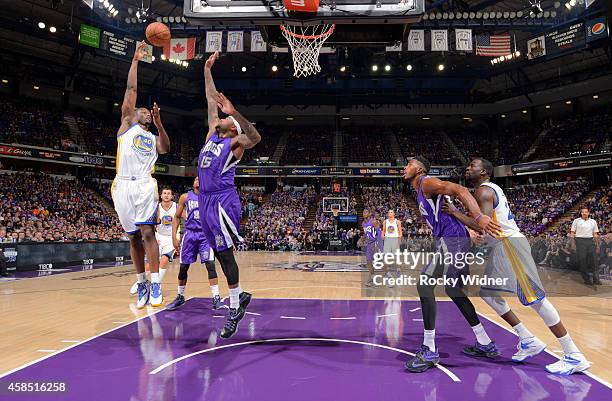 Harrison Barnes of the Golden State Warriors shoots against DeMarcus Cousins of the Sacramento Kings on October 29, 2014 at Sleep Train Arena in...