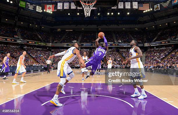 Darren Collison of the Sacramento Kings shoots against Andre Iguodala of the Golden State Warriors on October 29, 2014 at Sleep Train Arena in...