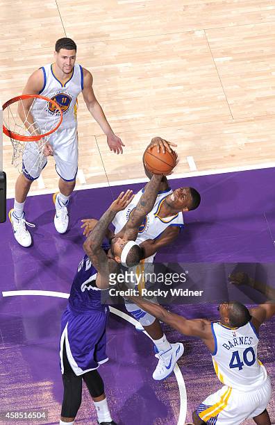 DeMarcus Cousins of the Sacramento Kings rebounds against Festus Ezeli of the Golden State Warriors on October 29, 2014 at Sleep Train Arena in...