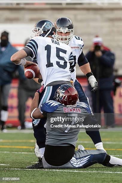 John Bowman of the Montreal Alouettes grabs a hold of Ricky Ray of the Toronto Argonauts during the CFL game at Percival Molson Stadium on November...