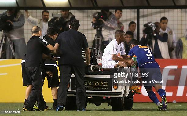 Robinho of Santos is injured during the match between Santos and Cruzeiro for Copa do Brasil 2014 at Vila Belmiro Stadium on November 5, 2014 in...