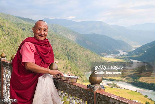 buddhist monk overlooking paro river valley - bhutan stock pictures, royalty-free photos & images