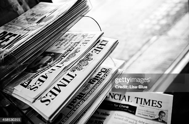 stack of newspapers. london - england. black and white - news stand stock pictures, royalty-free photos & images