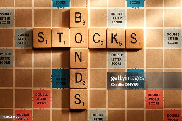 stocks and bonds - scrabble stockfoto's en -beelden