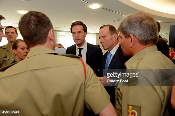 Netherlands Prime Minister Mark Rutte and Australian Prime Minister Tony Abbott speak to defence personnel during a visit to the Department of...