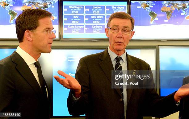 Netherlands Prime Minister Mark Rutte listens to special envoy Angus Houston during a visit to the Department of Foreign Affairs Crisis Centre on...