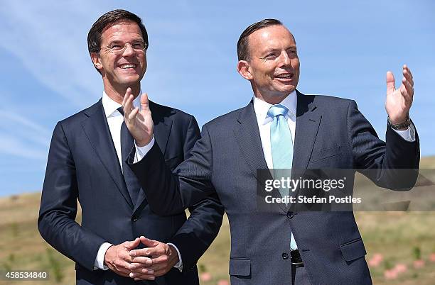 Netherlands Prime Minister Mark Rutte and Australian Prime Minister Tony Abbott speak before planting a silver birch tree at the National Arboretum...