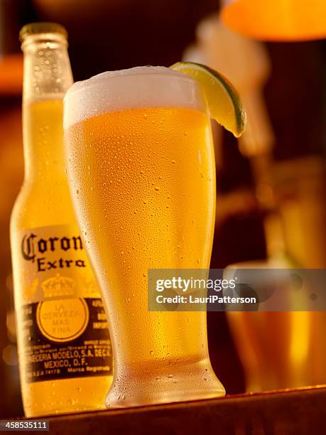 ice cold glass of corona beer - corona beer stockfoto's en -beelden