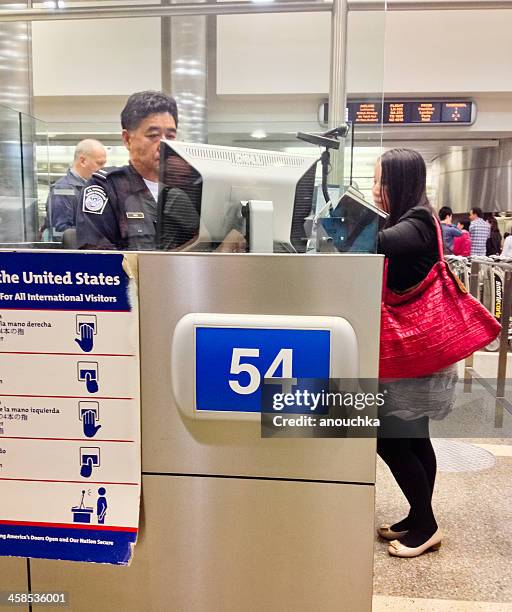 u.s. immigration officer checking documents of tourists - customs officer stock pictures, royalty-free photos & images
