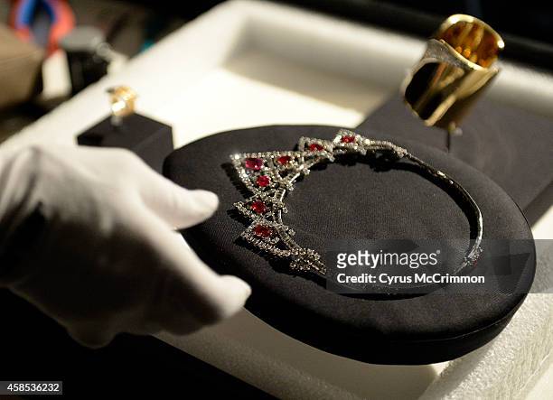Denver Art Museum installer placed Elizabeth Taylor's ruby and diamond Cartier necklace on display as they prepare on Thursday, November 6, 2014 for...