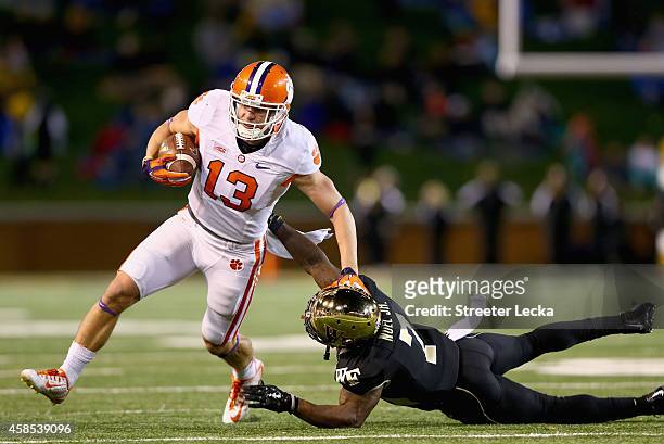 Adam Humphries of the Clemson Tigers tries to get away from Merrill Noel of the Wake Forest Demon Deacons during their game at BB&T Field on November...