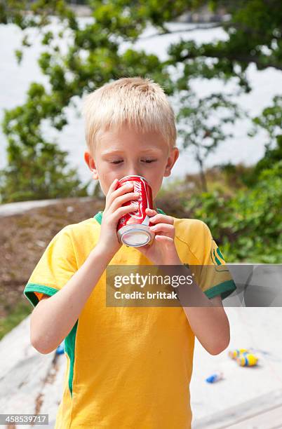 young boy drinking from cocacola can - boy drinking coke stock pictures, royalty-free photos & images