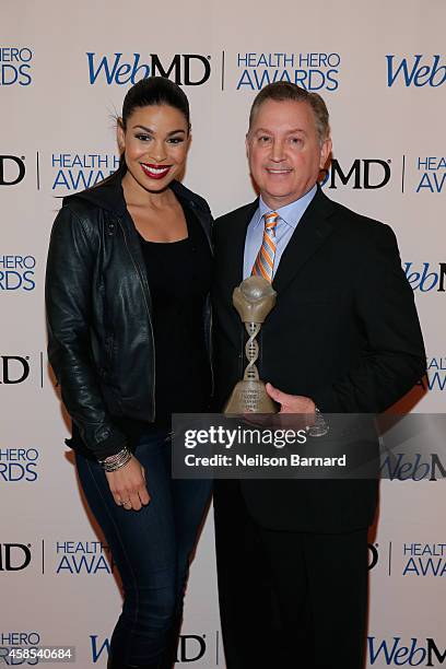 Musician Jordin Sparks and Honoree Dr. Frank Papay pose with an award backstage at the 2014 Health Hero Awards hosted by WebMD at Times Center on...