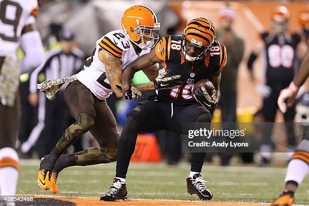 Joe Haden of the Cleveland Browns tackles A.J. Green of the Cincinnati Bengals after making a catch during the second quarter at Paul Brown Stadium...