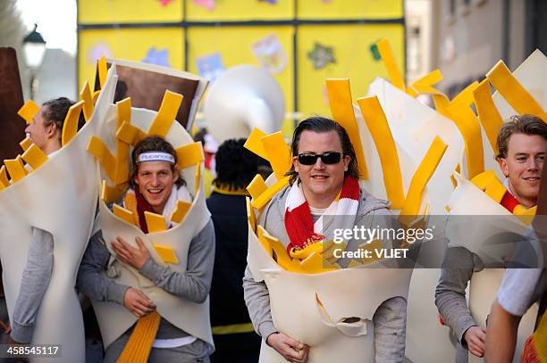 men dressed up as french fries in a carnival parade - fiesta stock pictures, royalty-free photos & images