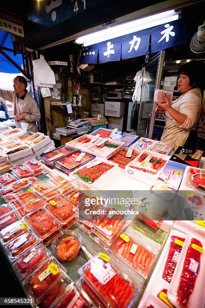 vendors serving customers, tsukiji fish market, tokyo - tsukiji fish market stock pictures, royalty-free photos & images
