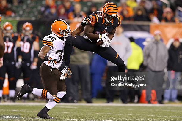 Mohamed Sanu of the Cincinnati Bengals catches a pass in front of K'Waun Williams of the Cleveland Browns during the fourth quarter at Paul Brown...