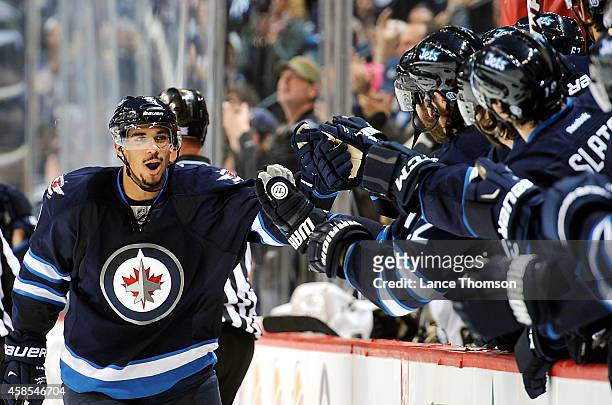 Evander Kane of the Winnipeg Jets celebrates his third period goal against the Pittsburgh Penguins with teammates at the bench on November 6, 2014 at...