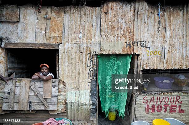 cafe and its owner in nairobi slum - domestic structure stock pictures, royalty-free photos & images