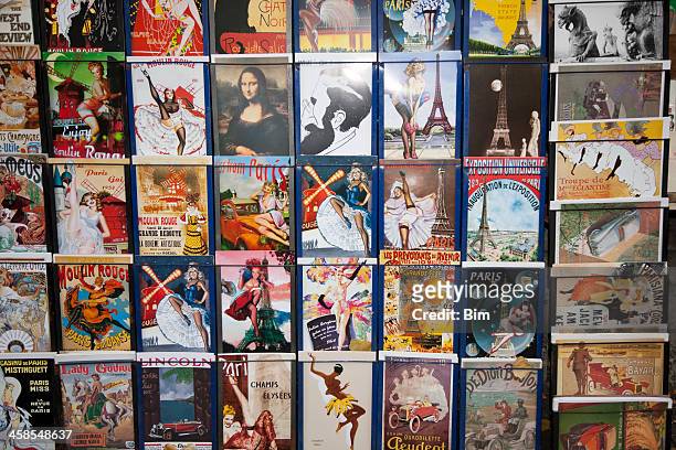 vintage posters and advertisements for sale at traditional bookstall, paris - paris postcard stock pictures, royalty-free photos & images