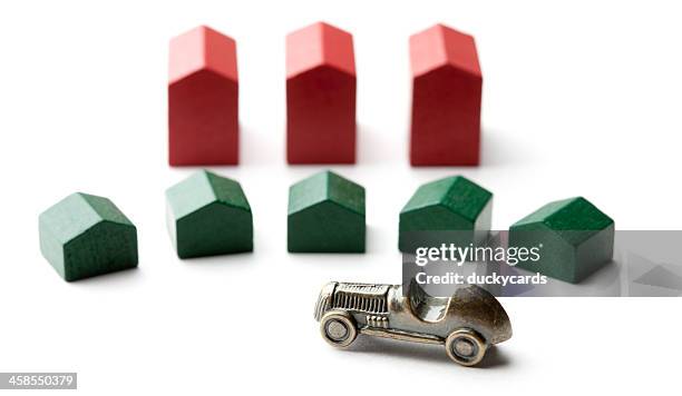 monopoly hotels and houses with car token - monopoly hotel stock pictures, royalty-free photos & images