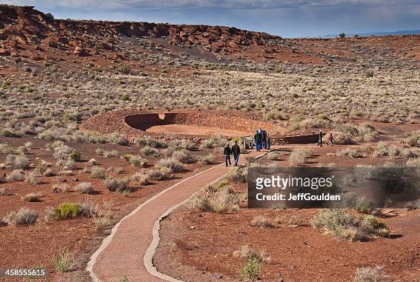 visitors walk to the ball court near wupatki pueblo - sinagua stock pictures, royalty-free photos & images