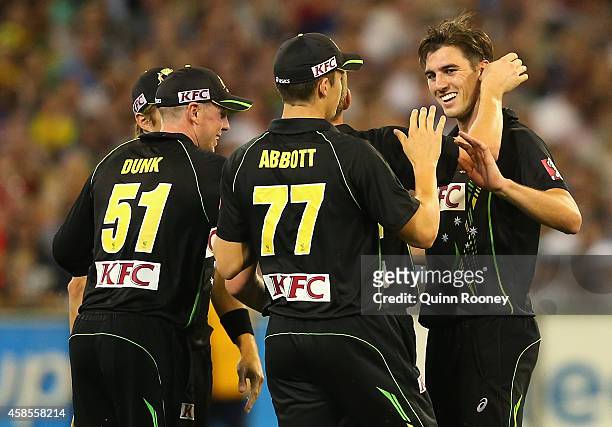 Patrick Cummins of Australia is congratulated by team mates after taking the wicket of Ryan McLaren of South Africa during game two of the...