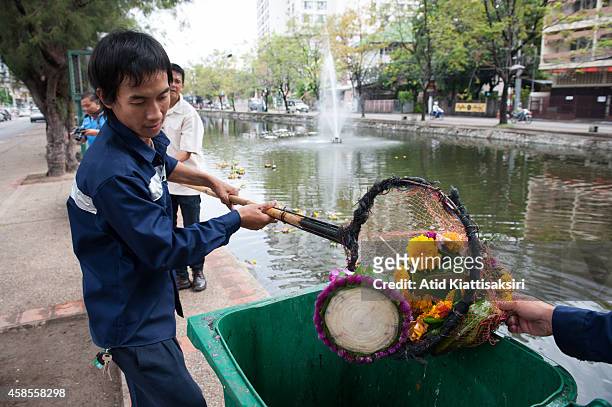 Workers collect krathong out of Chiang Mai's moat after the Loy Krathong festival. Every year, about 600 tons of Krathong are released into the Ping...