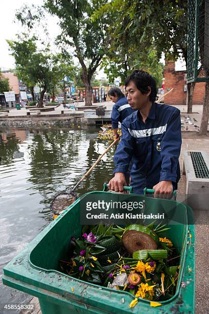 Workers collect krathongs out of Chiang Mai's moat at the Tapae gate during the Loy Krathong festival. Every year, about 600 tons of Krathong are...