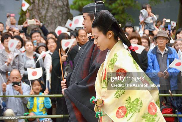 Bride Princess Noriko of Takamado and groom Kunimaro Senge walk to the hall in the Izumo Taisha grand shrine for their wedding ceremony on October 5,...