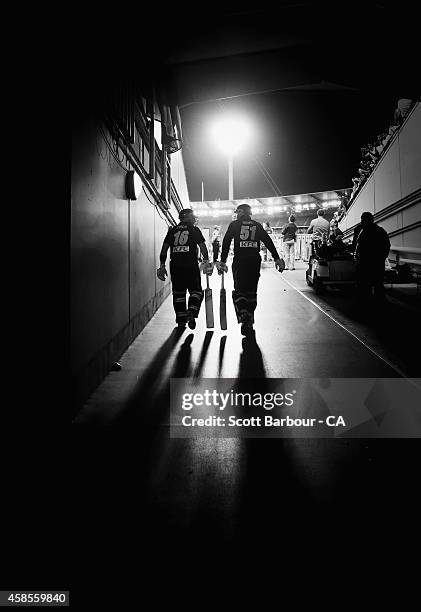 Aaron Finch and Ben Dunk of Australia walk out of the players tunnel to open the innings during game two of the International Twenty20 Series between...