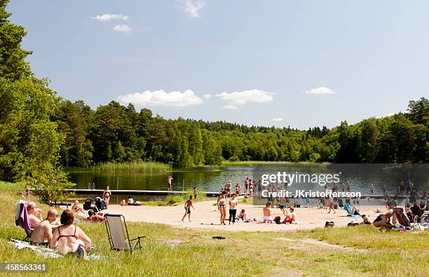 people at a swedish lake - stockholm beach stock pictures, royalty-free photos & images