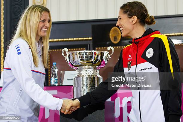 Petra Kvitova of the Czech Republic shakes hands with first day opponent Andrea Petkovic of Germany after a draw ceremony prior to the Fed Cup final...