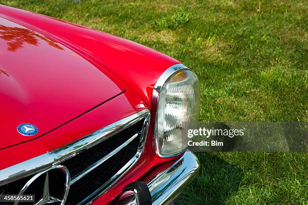 mercedes-benz 280sl pagoda, front detail against green grass - stock photo car chrome bumper stock pictures, royalty-free photos & images