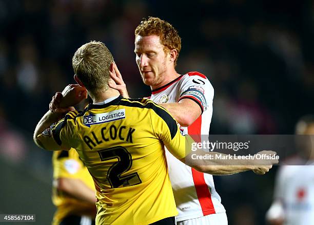 Dean Lewington of MK Dons pushes Craig Alcock of Sheffield United in the face during the Capital One Cup Fourth Round match between MK Dons and...