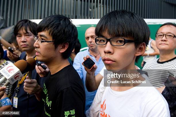 Students' association Scholarism founder Joshua Wong Chi-fung looks away while Hong Kong Federation of Students secretary general Alex Chow Yong-kang...