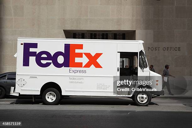 fedex delivery truck outside usps post office nyc - federal express stockfoto's en -beelden