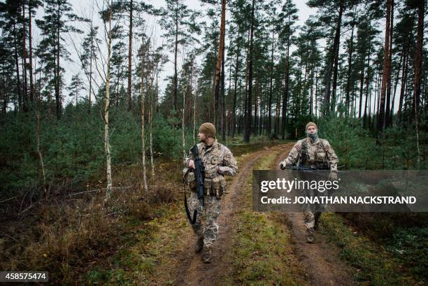 Soldiers from the Latvian National Armed Forces, part of the NBG Quick Response Force, patrol at Hagshult Airbase, part of the Forward Operation Base...