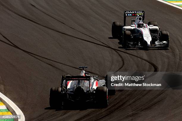 Valtteri Bottas of Finland and Williams approaches Adrian Sutil of Germany and Sauber F1 during practice ahead of the Brazilian Formula One Grand...